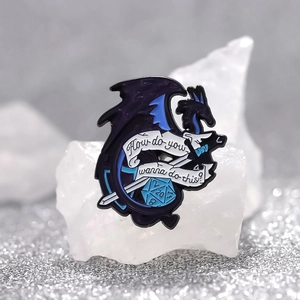 Blue dragon enamel pin with sword and d20 dice featuring DND fantasy gaming design