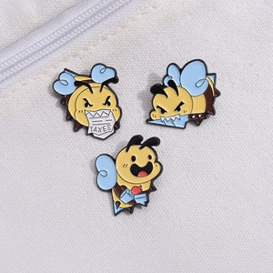 Set of three cute cartoon bee enamel pins in yellow and blue with a TAXES motif