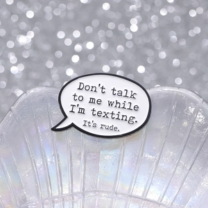 Funny speech bubble enamel pin with Don't talk to me text on iridescent shell base