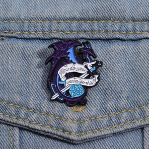 Blue dragon enamel pin with d20 dice and slogan pinned on blue denim jacket pocket