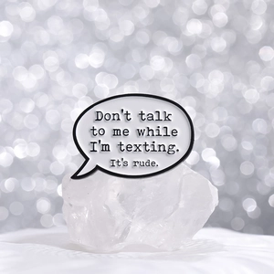 Funny speech bubble enamel pin with texting quote on a decorative white stone