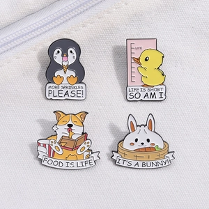 Set of four cute cartoon enamel pins featuring penguin, duck, corgi, and rabbit designs