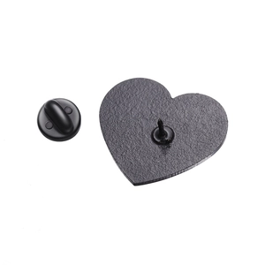 Back view of pink heart enamel pin with matte black texture and rubber clutch backing