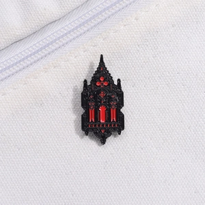 Detailed macro of a Gothic cathedral window enamel pin in striking black and red