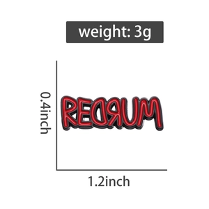 Macro shot of REDRUM enamel pin showing 0.4x1.2 inch dimensions and metal texture