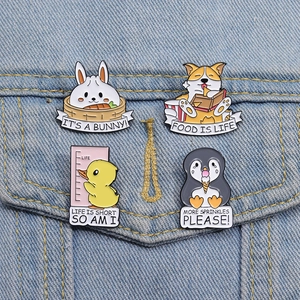 Detail of four cute animal enamel badges pinned on a blue denim jacket pocket