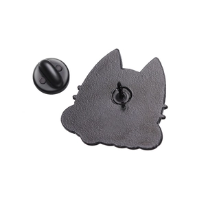 Detail view of the matte black enamel cat pin back with matching rubber clutch closure