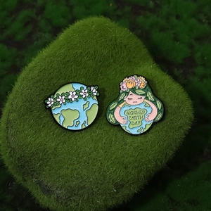 Creative Earth Day enamel pins featuring globe with floral wreath and Mother Earth girl