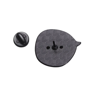 Detailed back view of enamel pin with non-slip grid texture and black rubber butterfly clutch