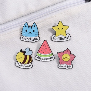 Set of 5 cartoon enamel pins with cat and honeybee designs on a white canvas bag