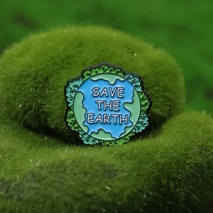 Eco-friendly Save the Earth enamel pin featuring a blue and green globe and forest design