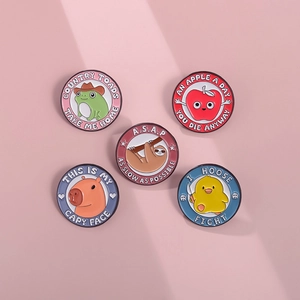 Cute cartoon animal enamel pins set featuring frog, sloth and capybara on pink background