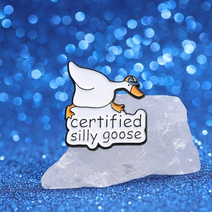 Broche en émail d'oie blanche avec chapeau bleu et texte certified silly goose
