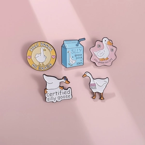 Set of five cute cartoon goose enamel pins with funny English phrases on pink background