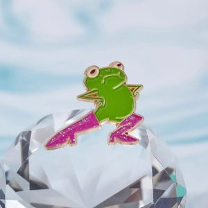Funny dancing green frog enamel pin with glitter purple boots on crystal background
