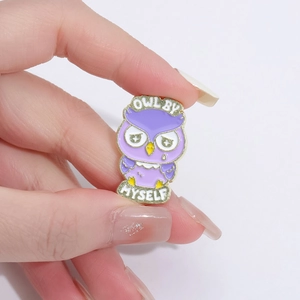 Detailed close-up of a purple owl enamel pin featuring the text Owl By Myself