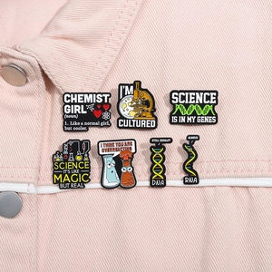 Science theme enamel pins set on pink denim jacket featuring microscope and DNA designs