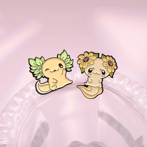 Cute cartoon axolotl enamel pins featuring sunflower and green leaf floral designs