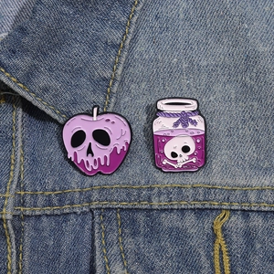 Halloween enamel pins set featuring poison apple and skull potion on denim jacket