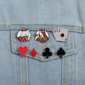 Detail of 7-piece playing card enamel pins set pinned on a light blue denim jacket