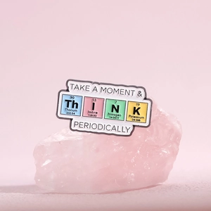 Creative enamel pin with THINK design using periodic table elements on pink quartz stone