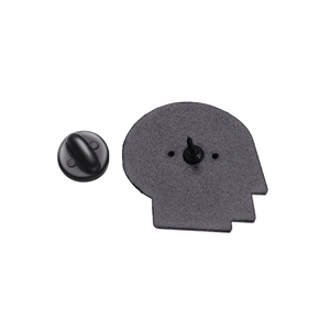 Macro view of a brain shaped metal brooch back with rubber pin clutch and secure fastener