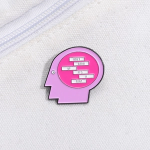 Artistic pink brain head enamel pin badge with Don't Grow Up It's A Trap slogan