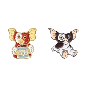 Creative cute cartoon Gremlin enamel pin set with Mogwai character holding blue cup