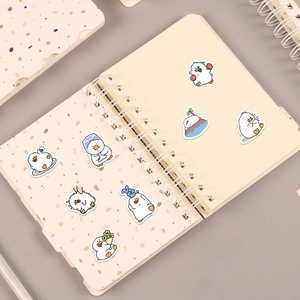 Detailed view of cute cartoon duck stickers on a notebook with various creative poses