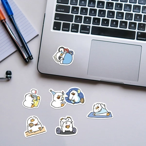 Detail shot of cute cartoon duck stickers on a laptop and notebook for decoration