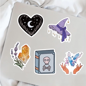 Detail of five mystical stickers including witch hat and crystals on a tablet back
