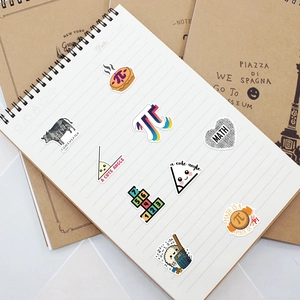 Close-up of mathematical formula stickers on a notebook featuring creative geometry designs