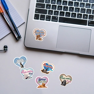 Retro heart puppy and kitten stickers applied on a silver laptop for decoration