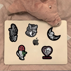 Gothic PVC stickers featuring skulls and butterflies on a laptop surface