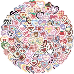 Detailed view of colorful heart-shaped decorative stickers with cute patterns on white background