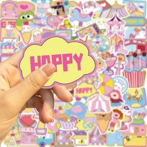 Close-up of colorful cartoon stickers featuring carousel and sweets held by hand