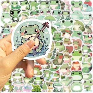 Close-up of small waterproof cartoon frog stickers showing the size and matte texture