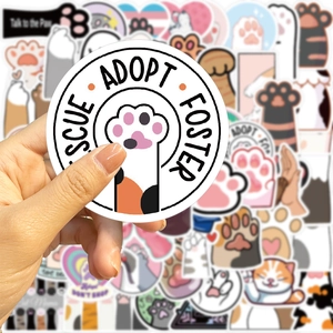 Close-up of waterproof cartoon cat paw rescue stickers for laptops and luggage