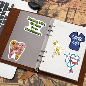 Macro view of nursing theme stickers with healthcare hero slogans on a notebook