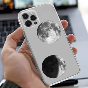 Close-up of clear phone case with realistic moon phases print on a silver smartphone
