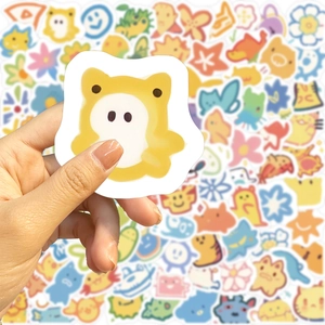 Hand holding cute cartoon animal stickers for laptop and DIY guitar decoration set