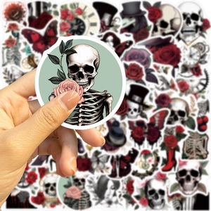 Close-up of a hand holding a waterproof Gothic punk rose sticker for laptop and guitar