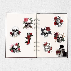 Detail of gothic punk skull and red rose waterproof stickers on a white binder