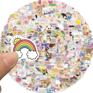Détail d'un autocollant dessin animé étanche avec arc-en-ciel sur une pile de décalcomanies