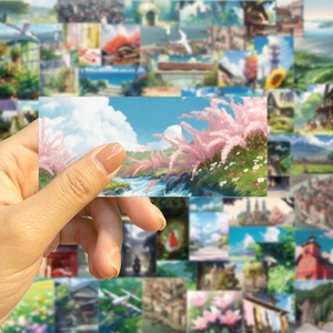 Close-up of matte anime landscape sticker with pink trees and blue sky for DIY decoration