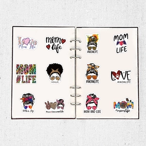 Detailed view of 12 Mom Life stickers with sunflower and leopard patterns on a white notebook