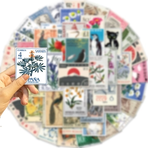 Close-up of vintage stamp stickers with botanical designs for scrapbooking and DIY