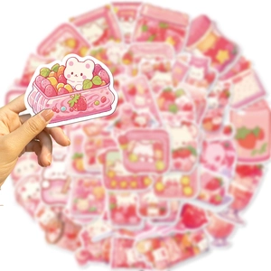 Close-up of pink strawberry and white bear cartoon stickers for journaling and DIY decor