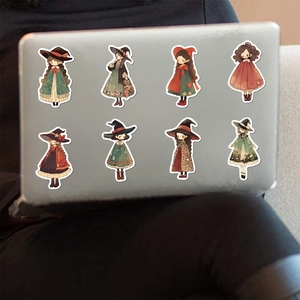 Cartoon witch stickers applied to a silver laptop lid for creative DIY decoration