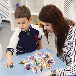Kid and adult playing with 3D miniature cartoon building stickers for DIY decor
